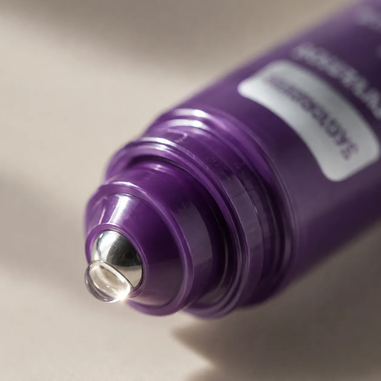 THICKROOT serum bottle angled on stone